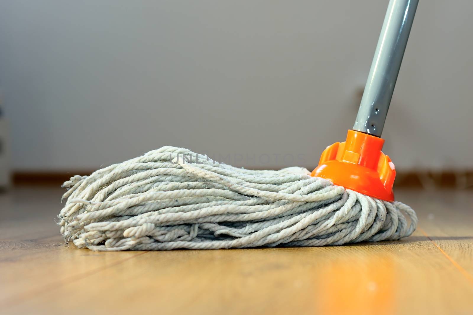 cleaning wooden floor with orange wet mop