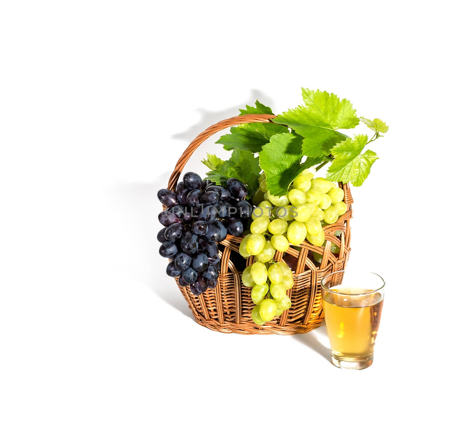 Grape with leaves and grape juice isolated on white. With clipping path. Full depth of field.