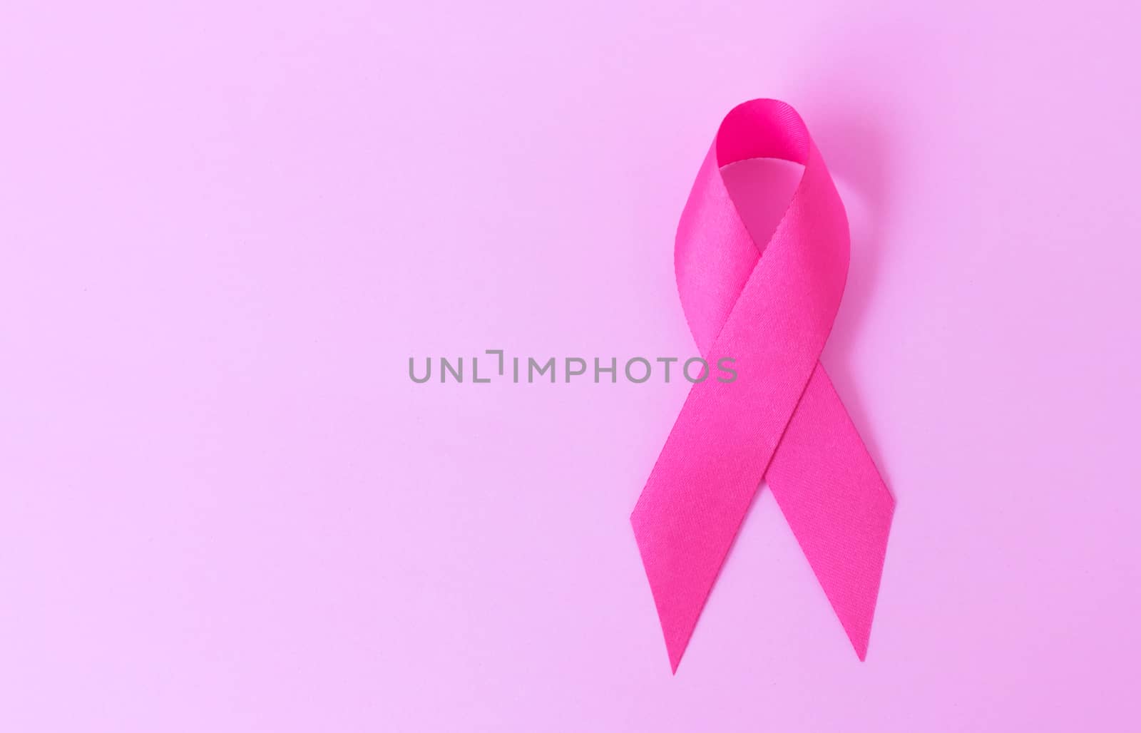 Pink ribbon on pink background, Awareness breast cancer concept