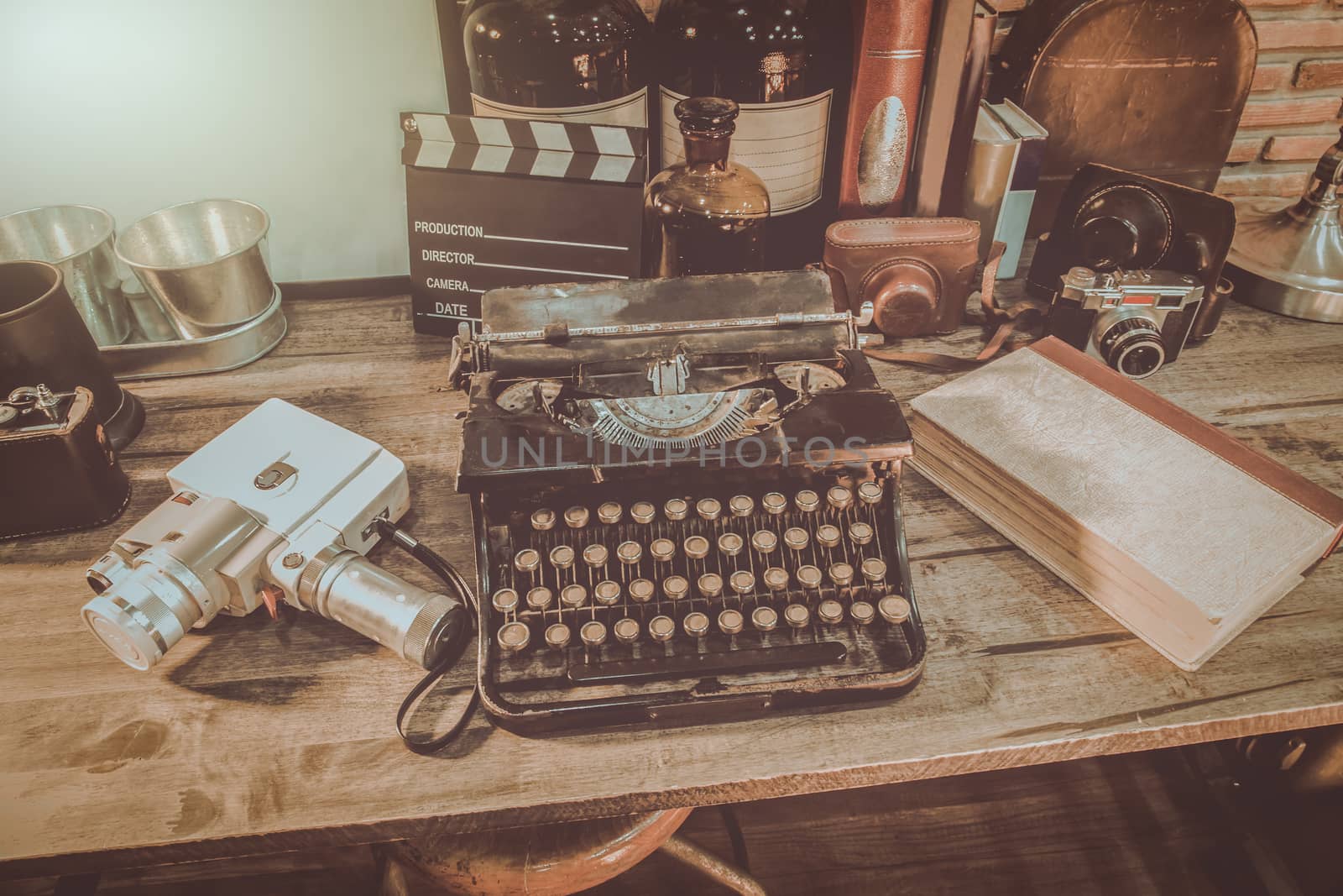 Old typewriter vintage ornaments and the camera, which is equipped to deliver communication messages. on a wooden table.