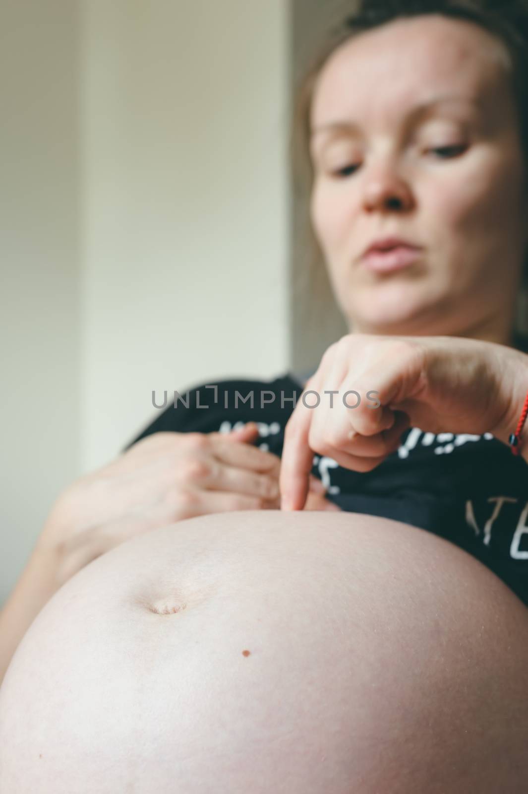 Big belly of pregnant woman closeup, nine month