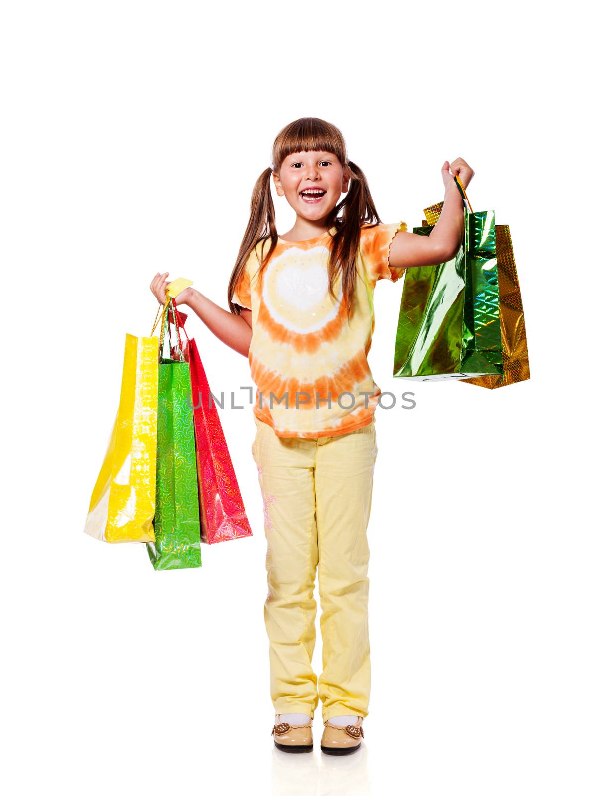 Smiling six years Girl holding presents bags isolated