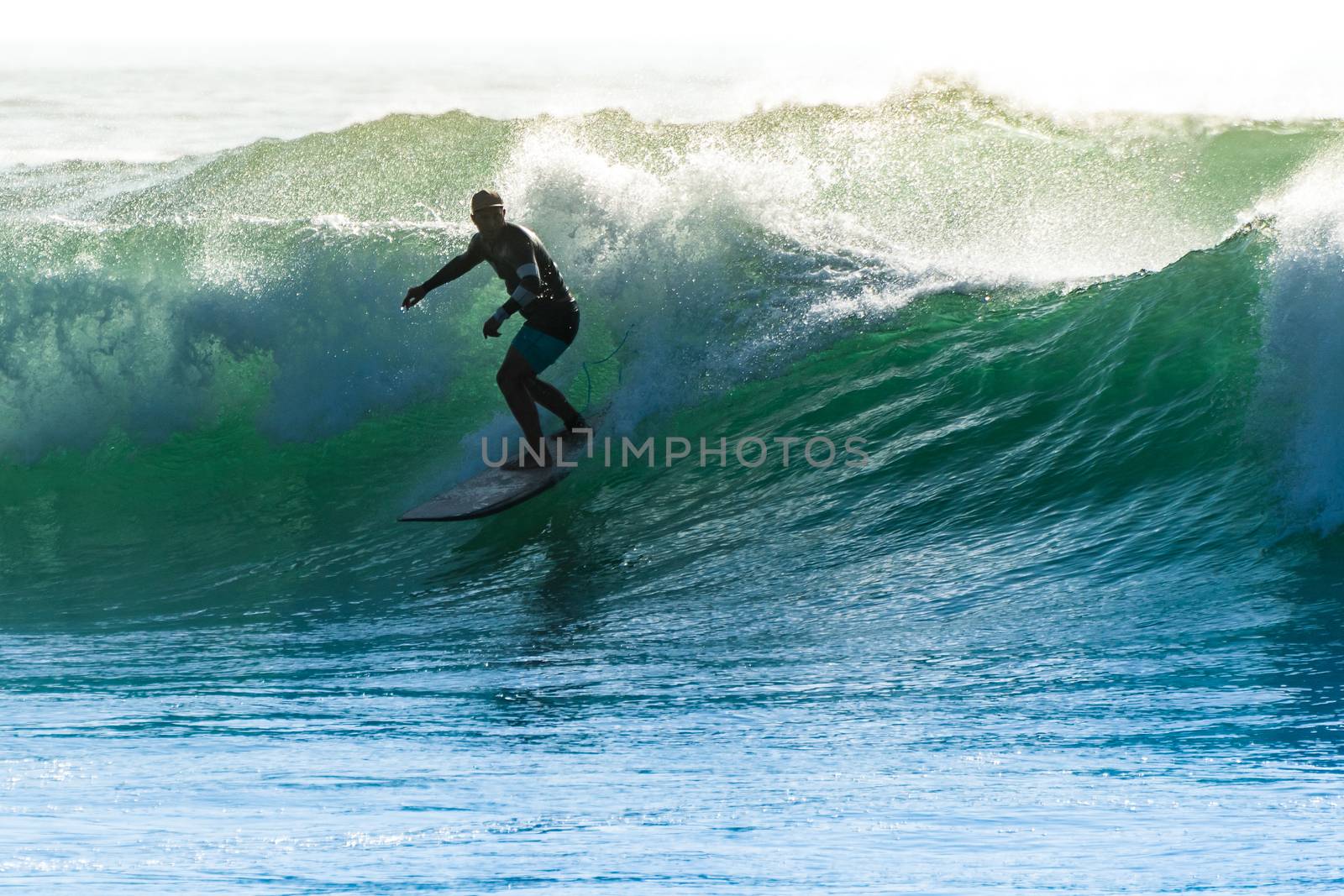 Surfer in action on the ocean waves on a sunny day.