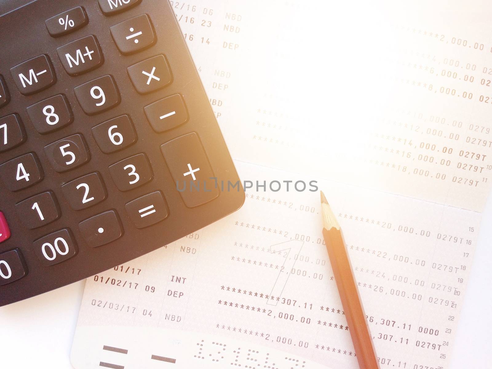 Business, finance, savings or loan background concept ; Pencil, calculator and savings account passbook or financial statement on white background