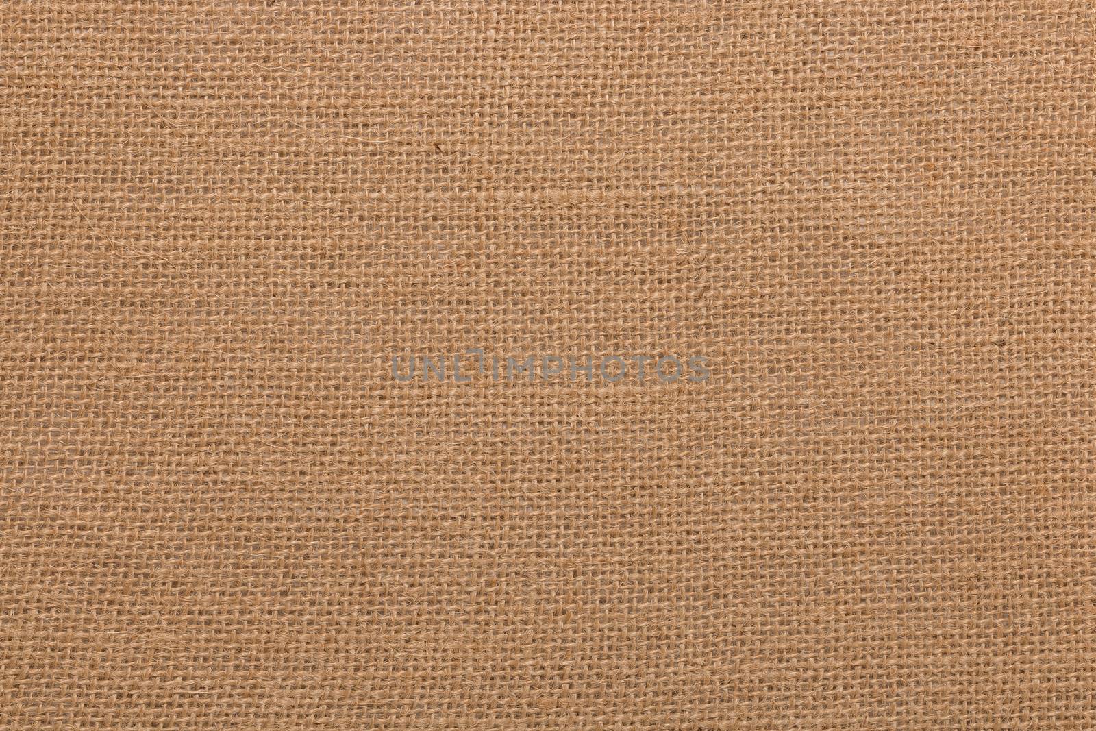 Burlap background and texture, The texture of the burlap, closeup with yellow tint