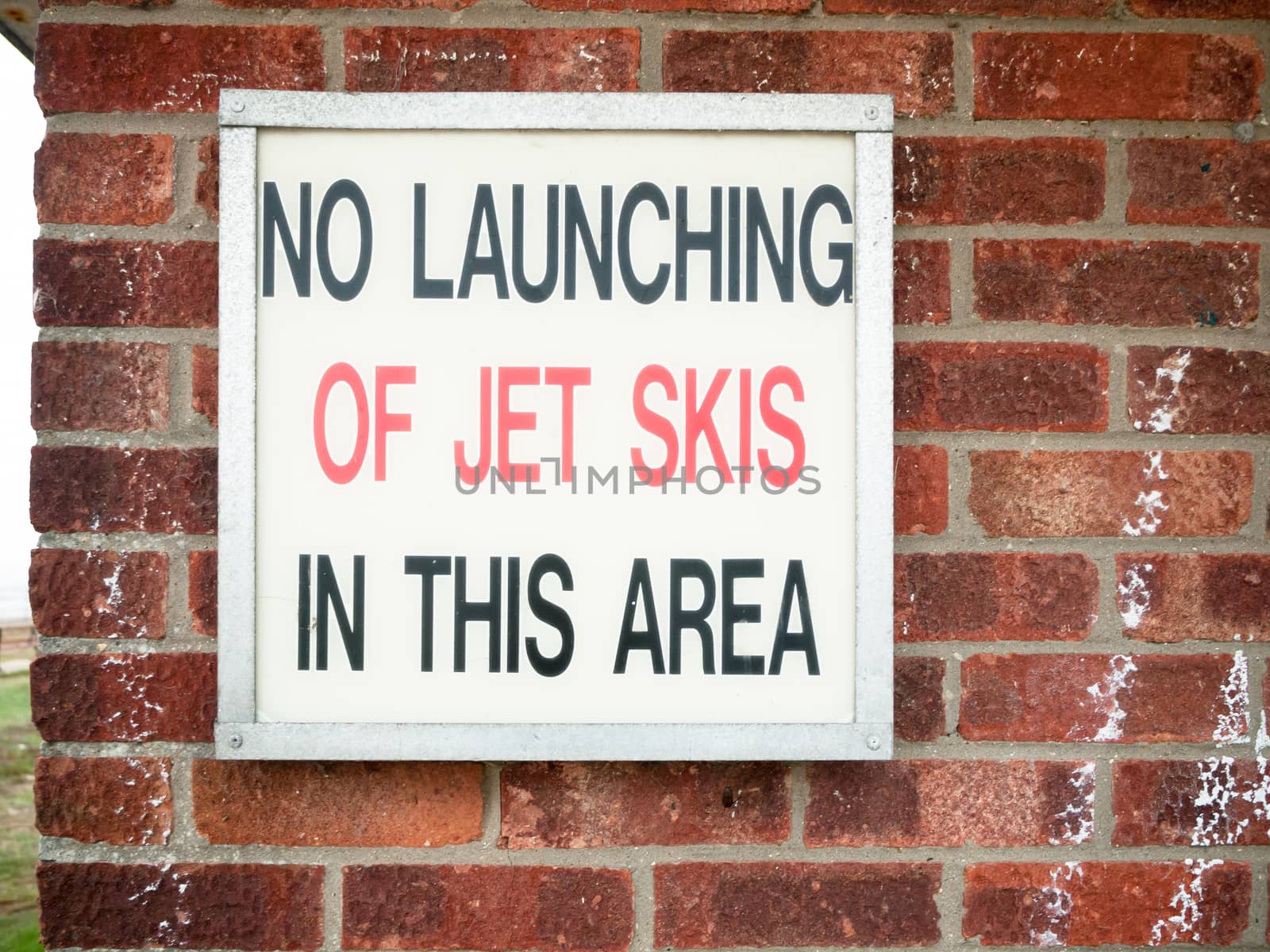 old retro sign lettering on wall saying no launching of jet skies in this area; England; UK