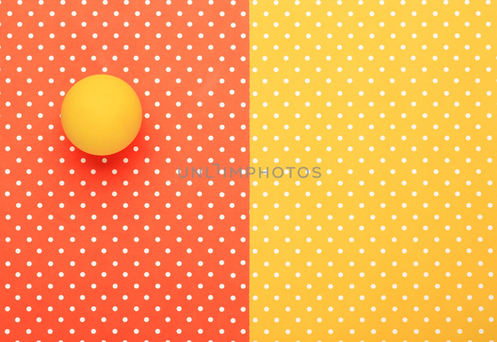 Yellow ball  with colorful topped background