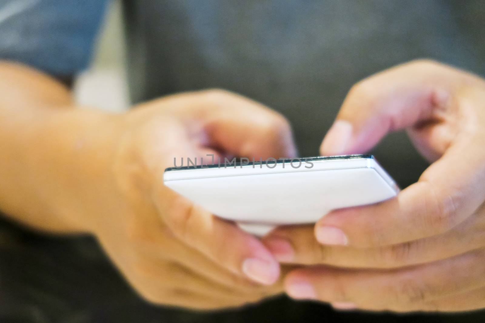 close up of hand typing on phone