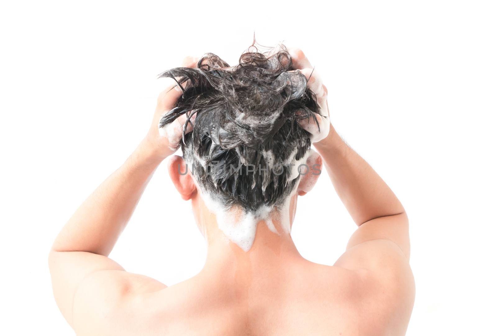 Closeup young man washing hair with white background, health care concept