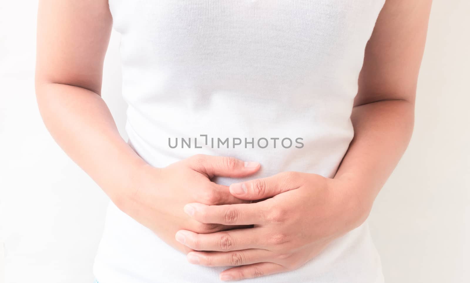 Closeup woman stomach ache with white background, health care and medical concept