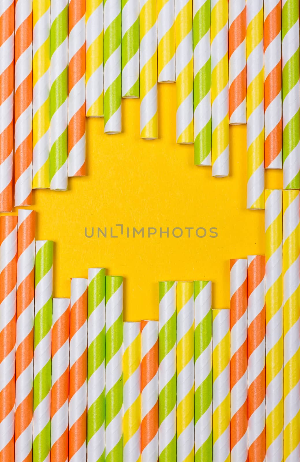 close-up colorful fancy drinking straws, fancy tube for party on the yellow background