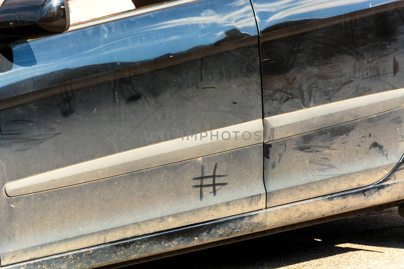 Side view of a filthy car. Concept hashtag #Wasch Me Car Wash