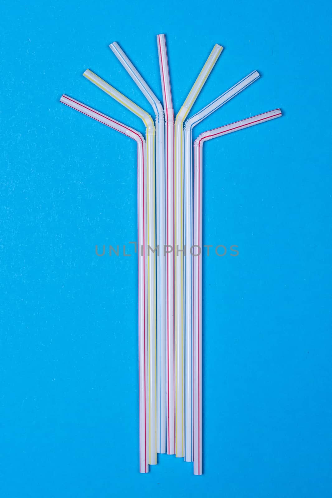 close-up colorful fancy drinking straws, fancy tube for party on the blue background
