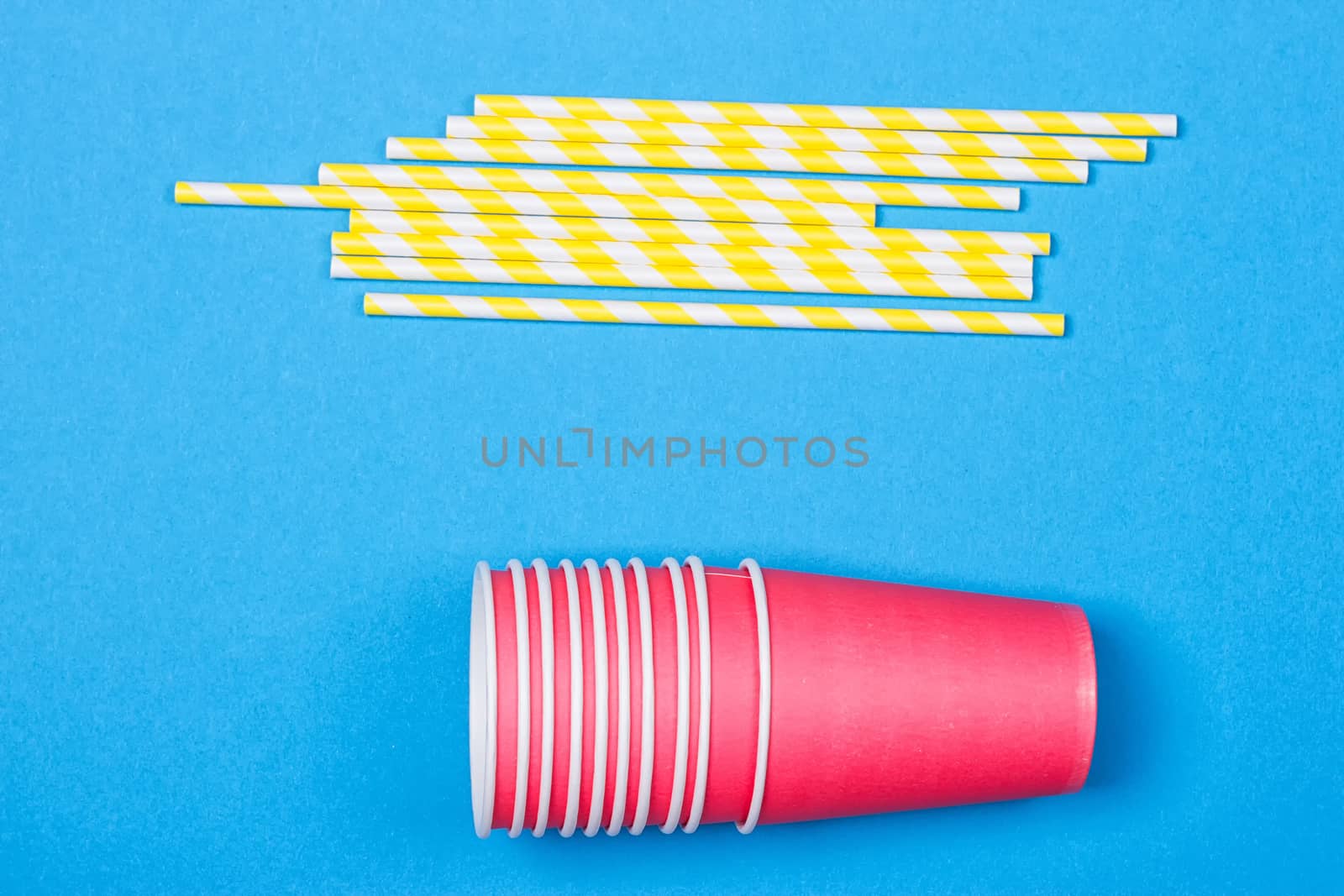 Colorful paper cups and striped straws by victosha