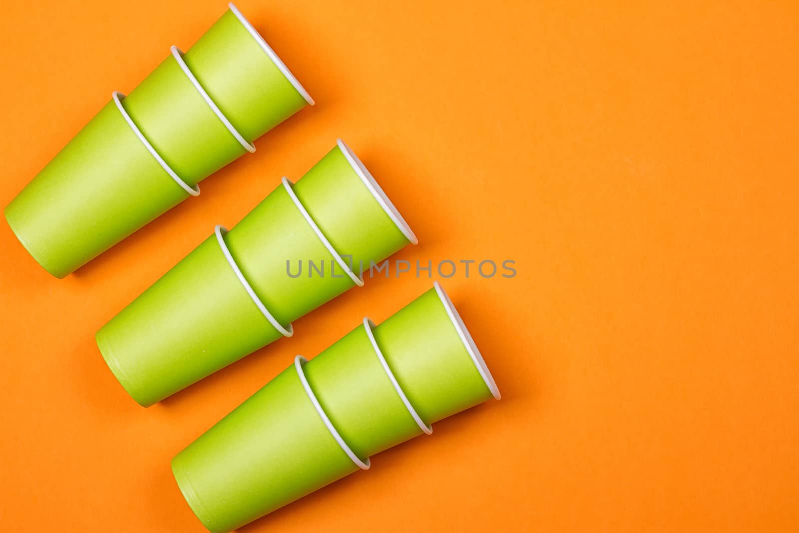 recycling colorful paper glass on the orange background