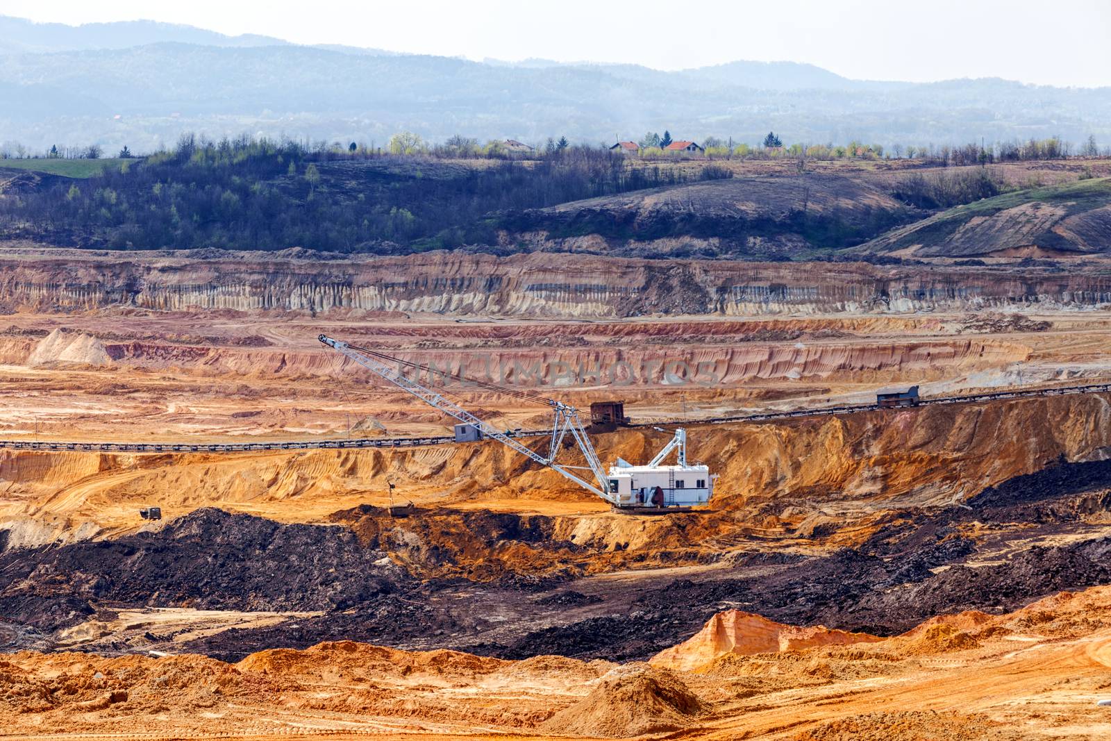 Open coal mining pit with heavy machinery