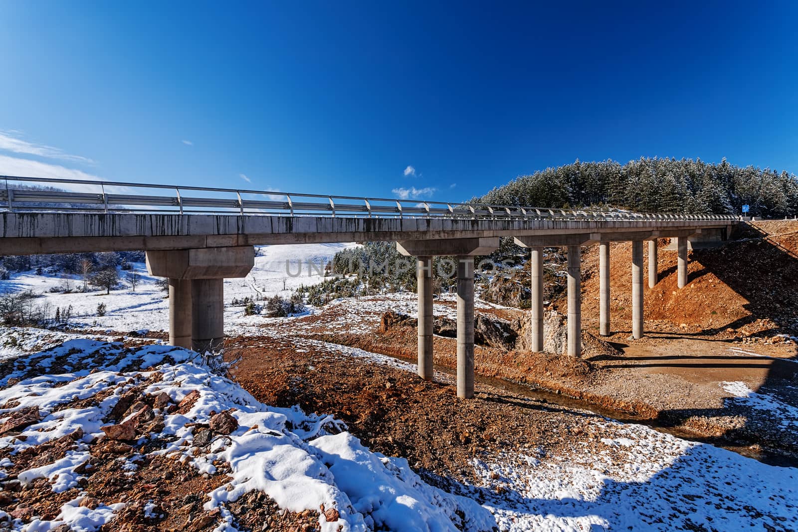 Mountain bridge in winter with snow and blue sky, Zlatibor mountain, Serbia