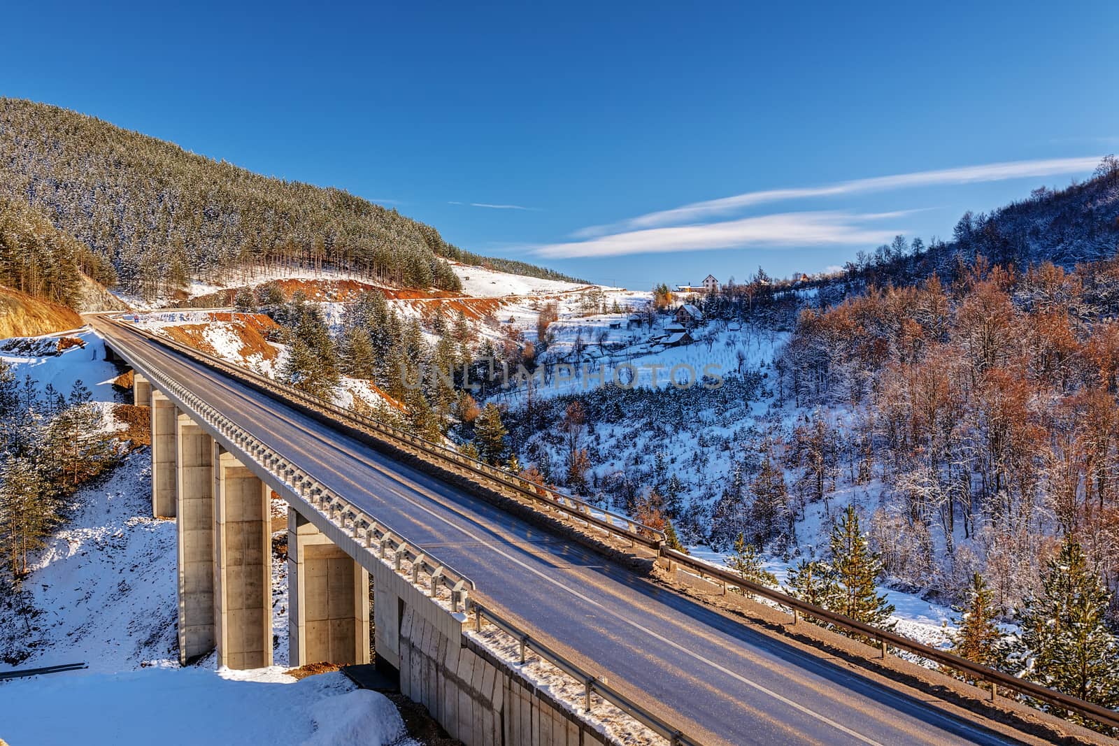 mountain bridge in winter with snow and blue sky, zlatibor mountain, serbia