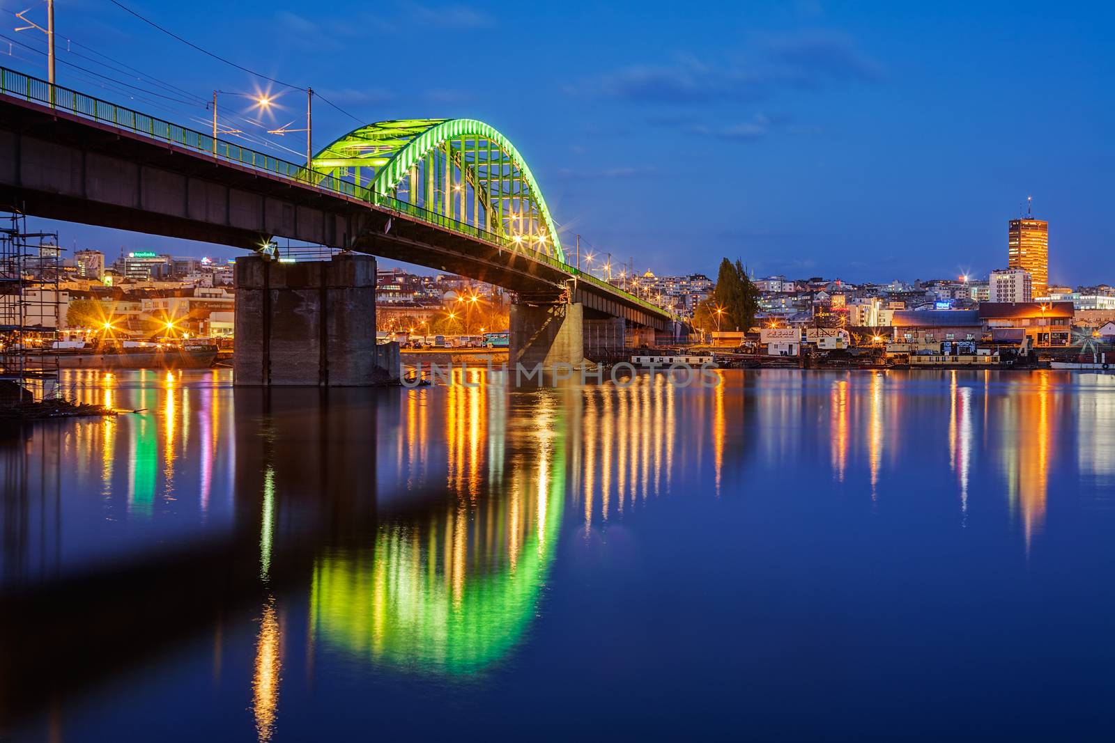 Panorama of Belgrade  at night with green lit bridge
