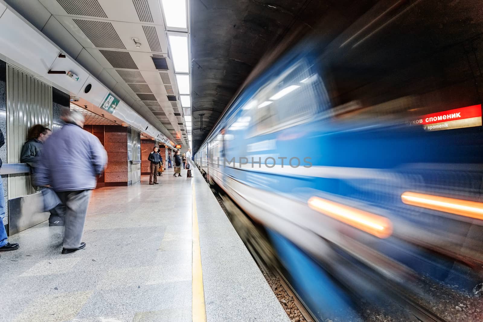 Fast moving blurred train entering train station