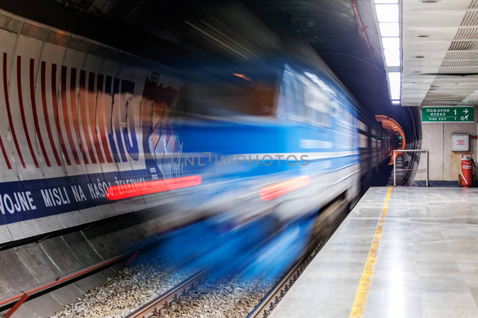 Fast moving blurred train entering train station