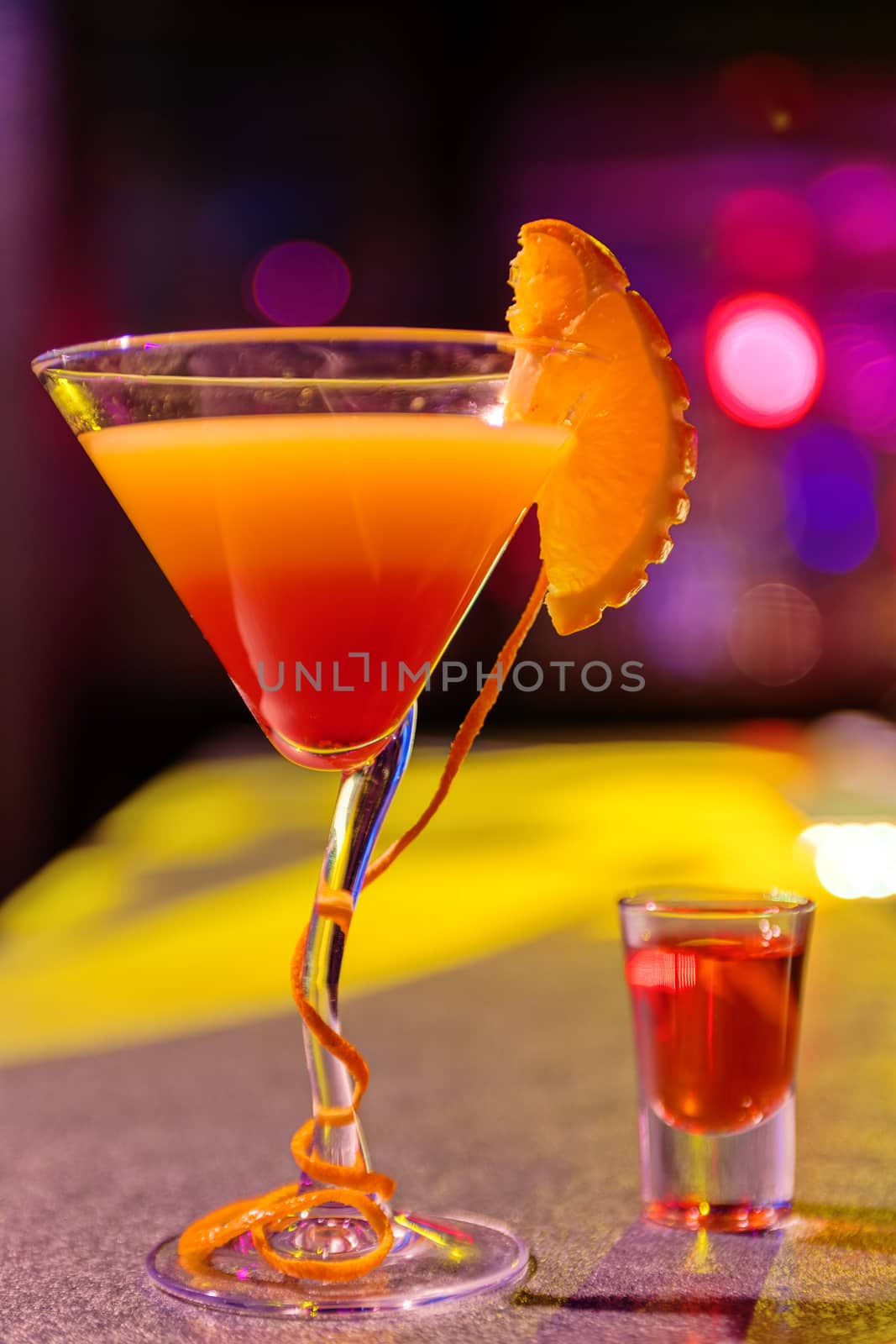 Close up of cocktail at the bar in a night club with vivid colors