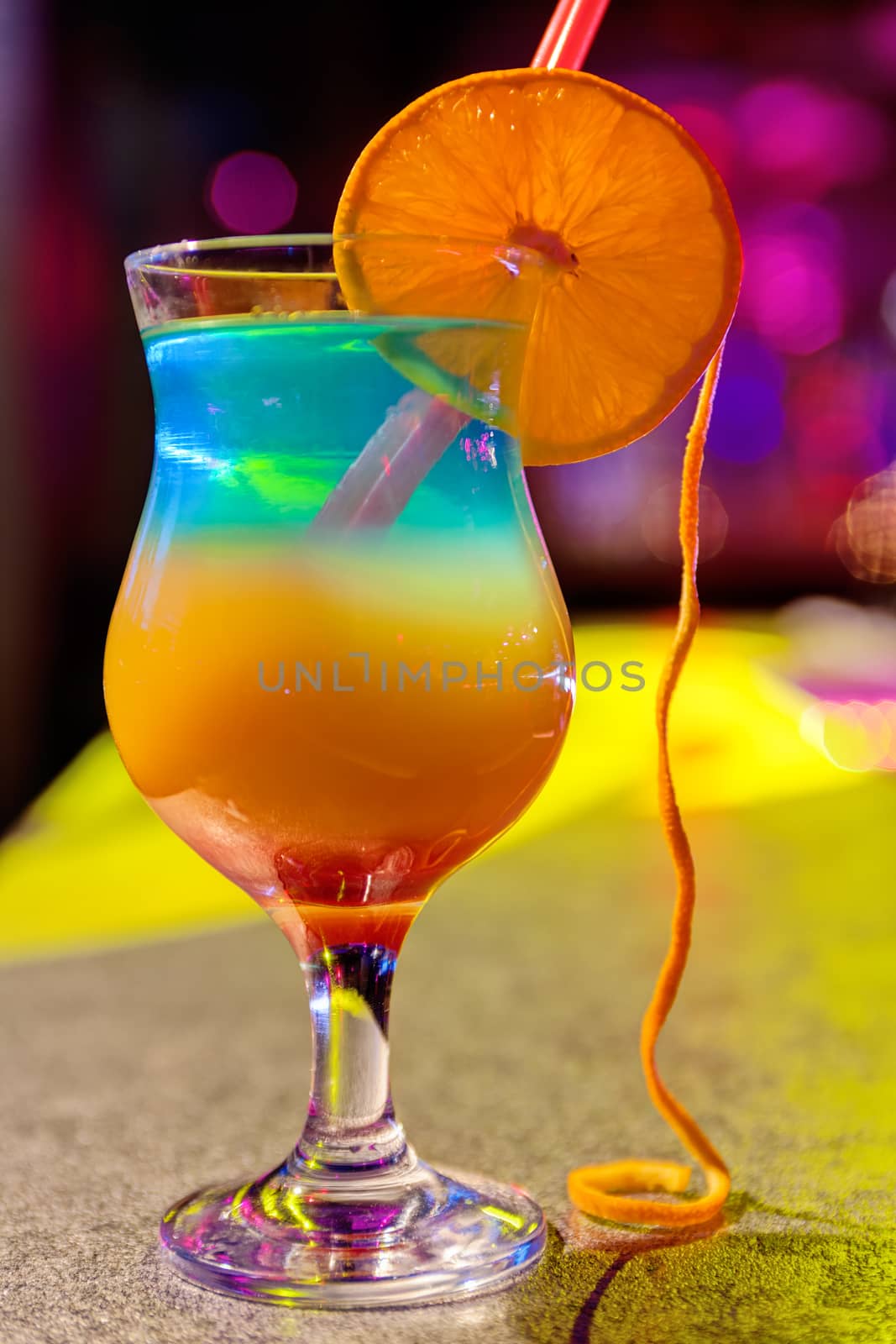 Close up of cocktail at the bar in a night club with vivid colors