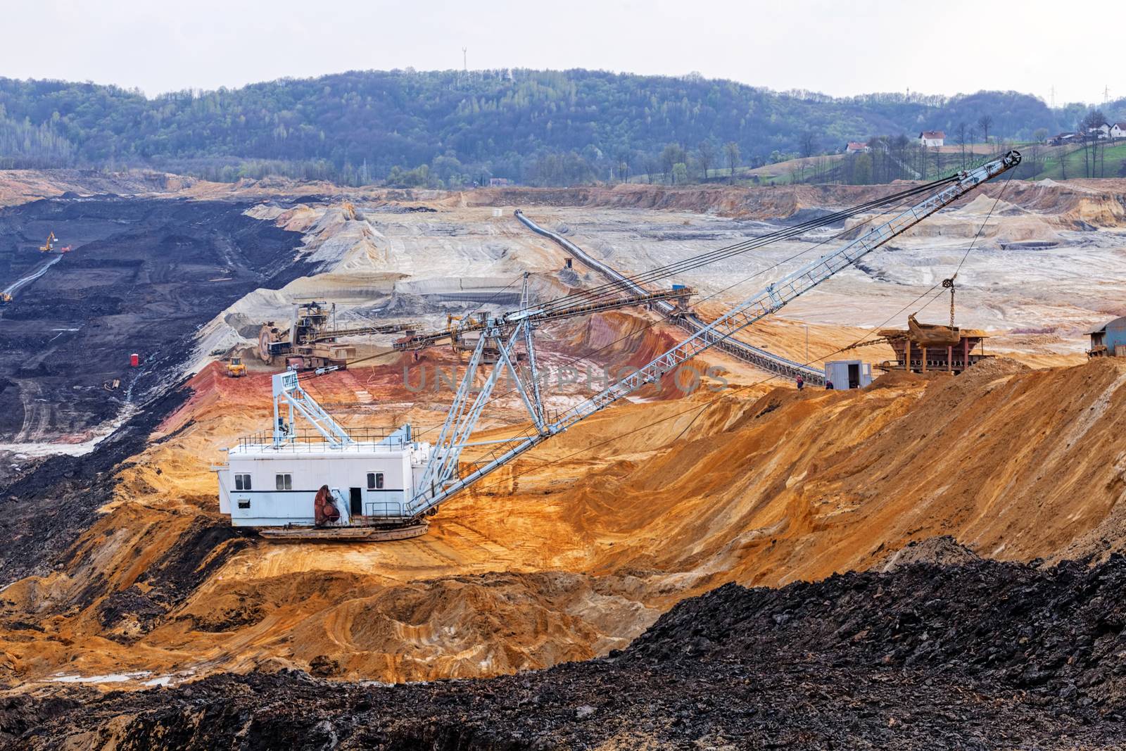 open coal mining pit with heavy machinery