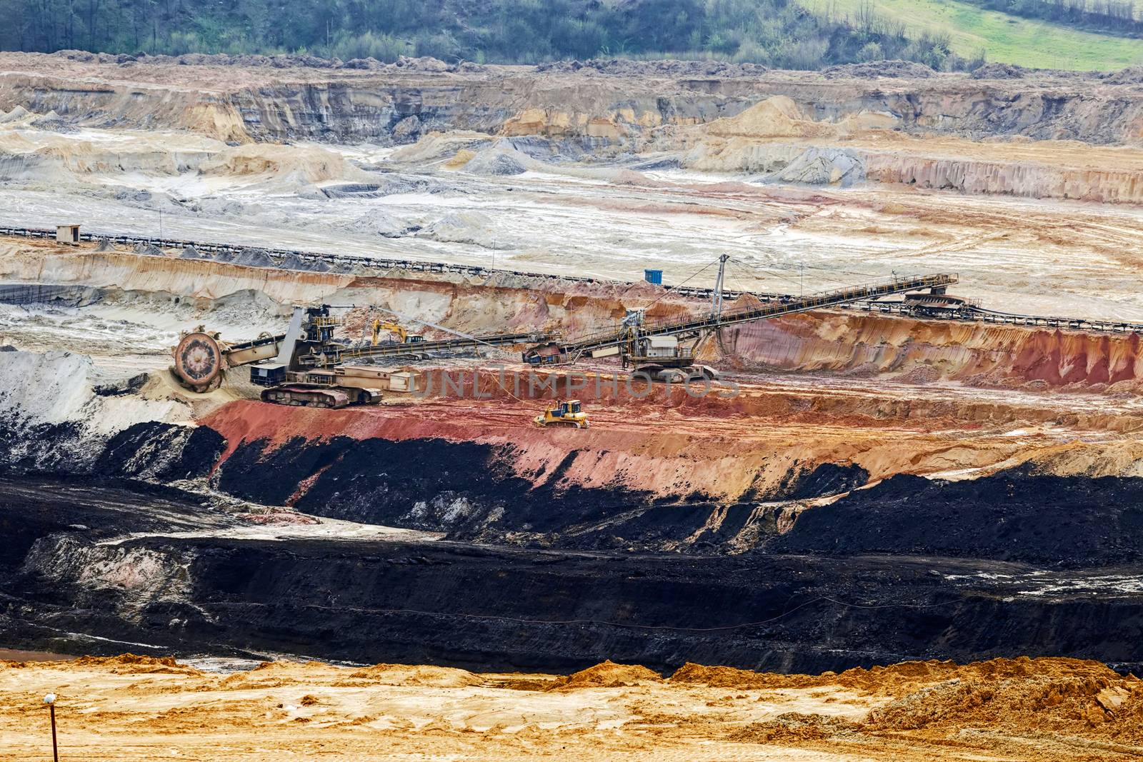 open coal mining pit with heavy machinery