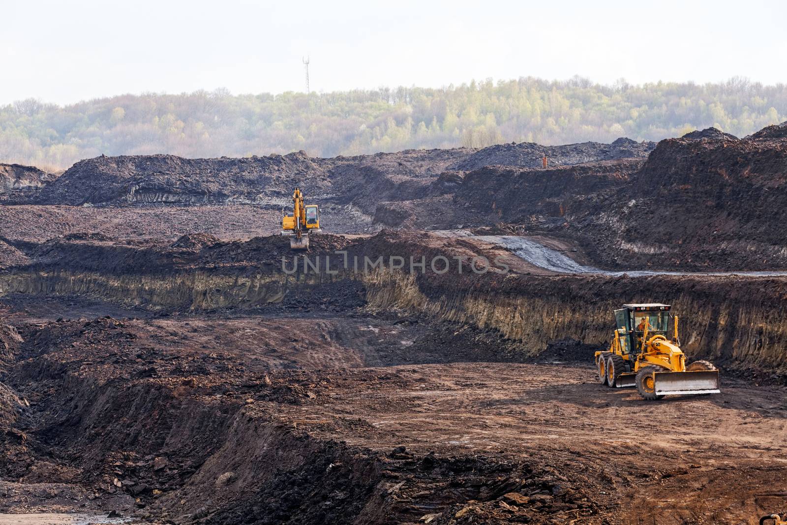 open coal mining pit with heavy machinery
