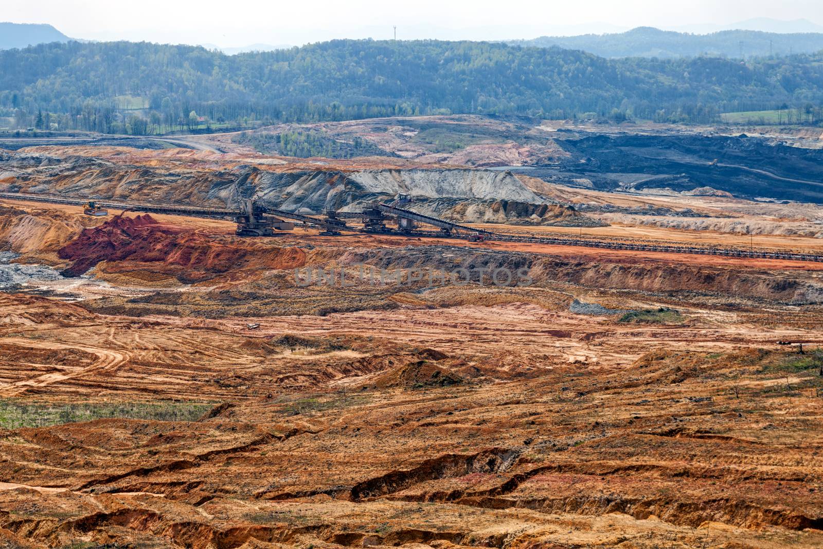 open mining pit with heavy machinery