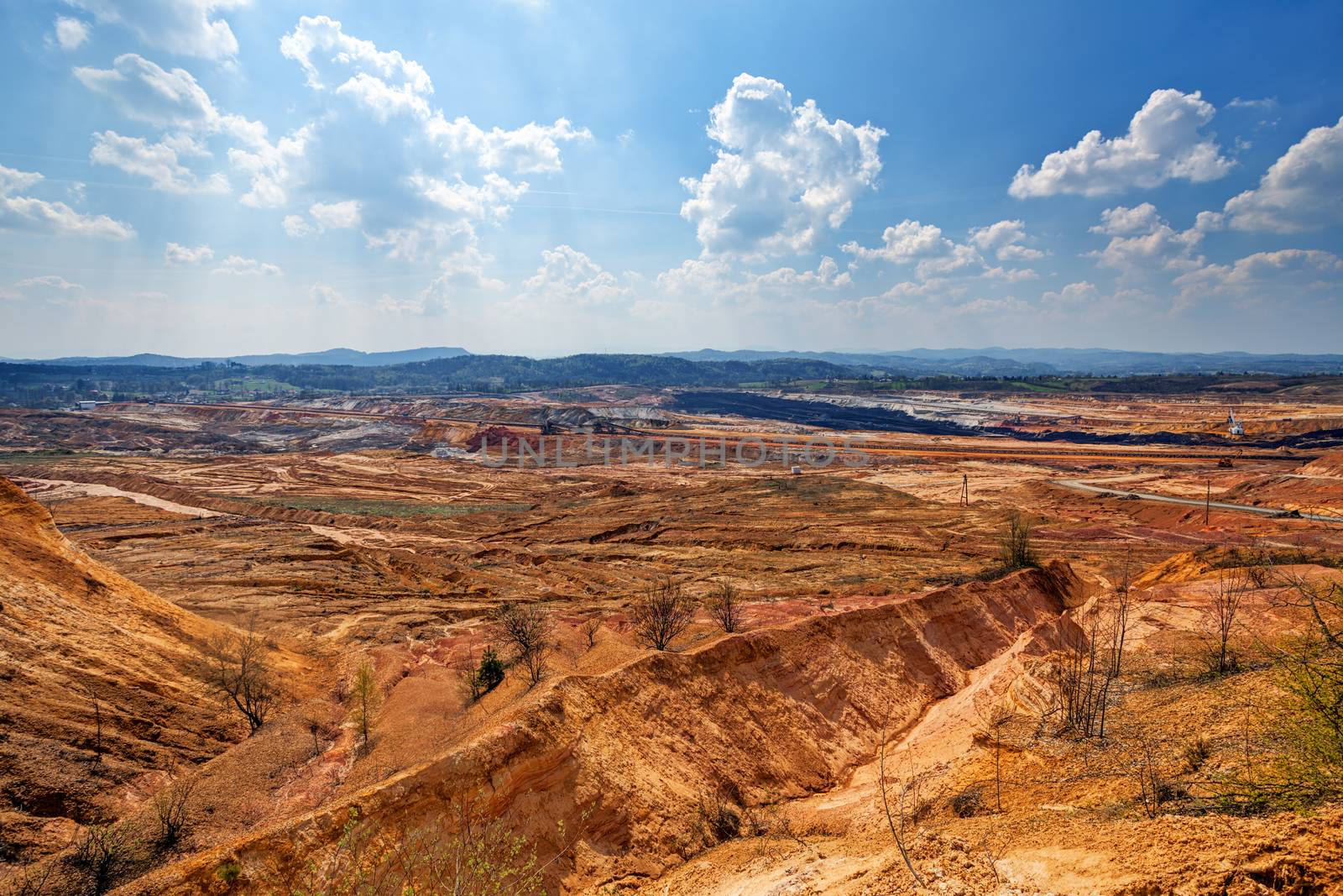 open coal mining pit with heavy machinery