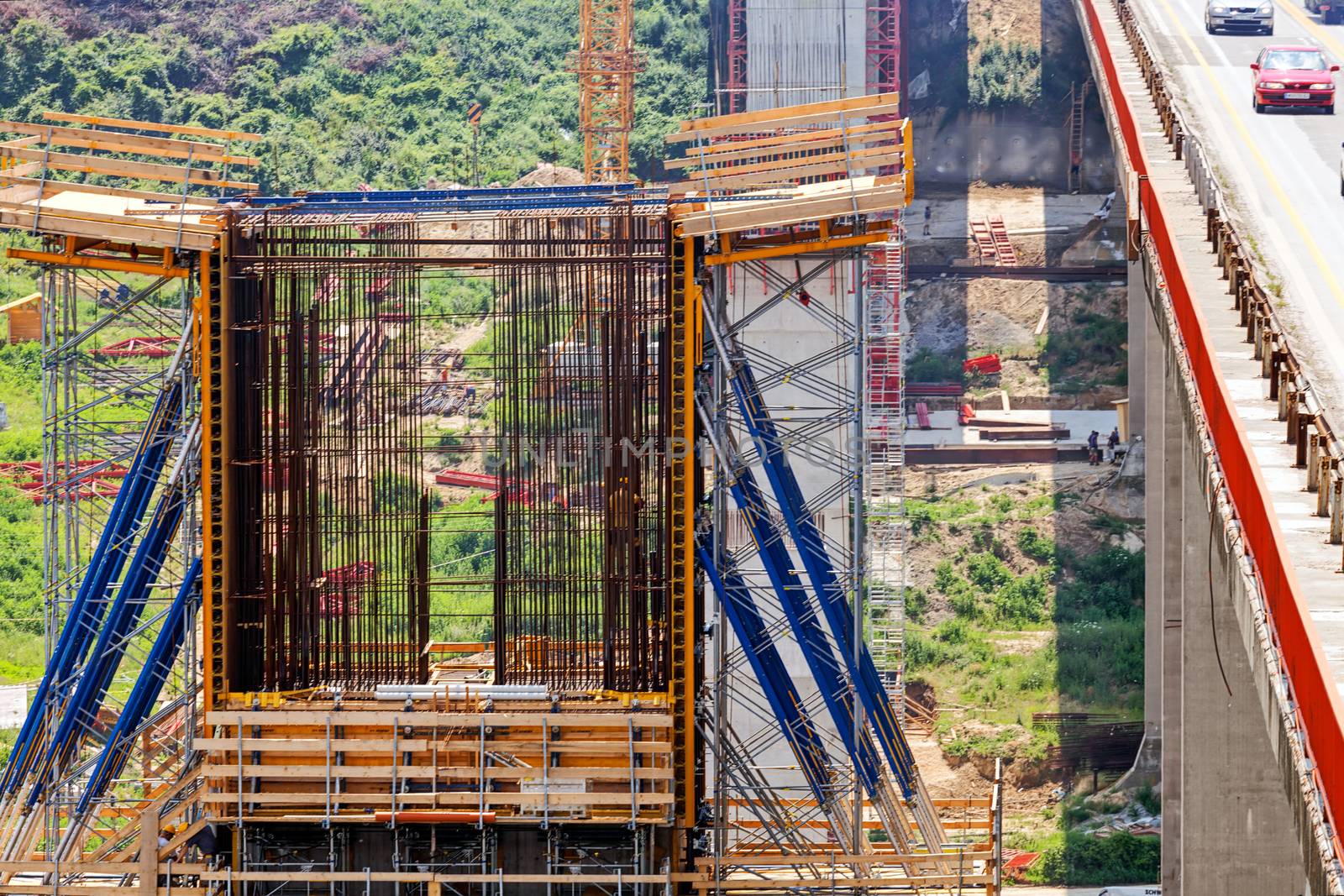 high altitude concrete bridge construction with crane and framework