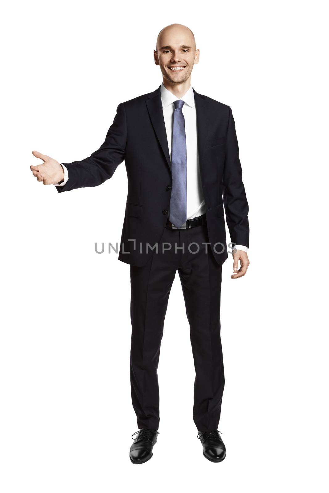 Young businessman greets his guests. Portrait of man in suit isolated on white background.