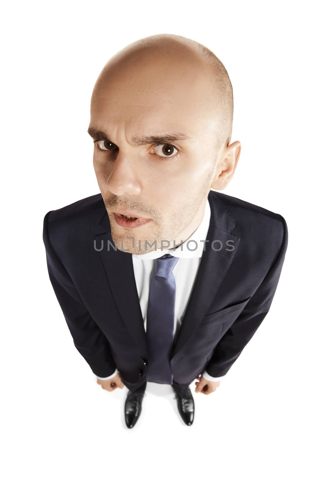 Young bald man looks into the camera. Copy space. Isolated on white.