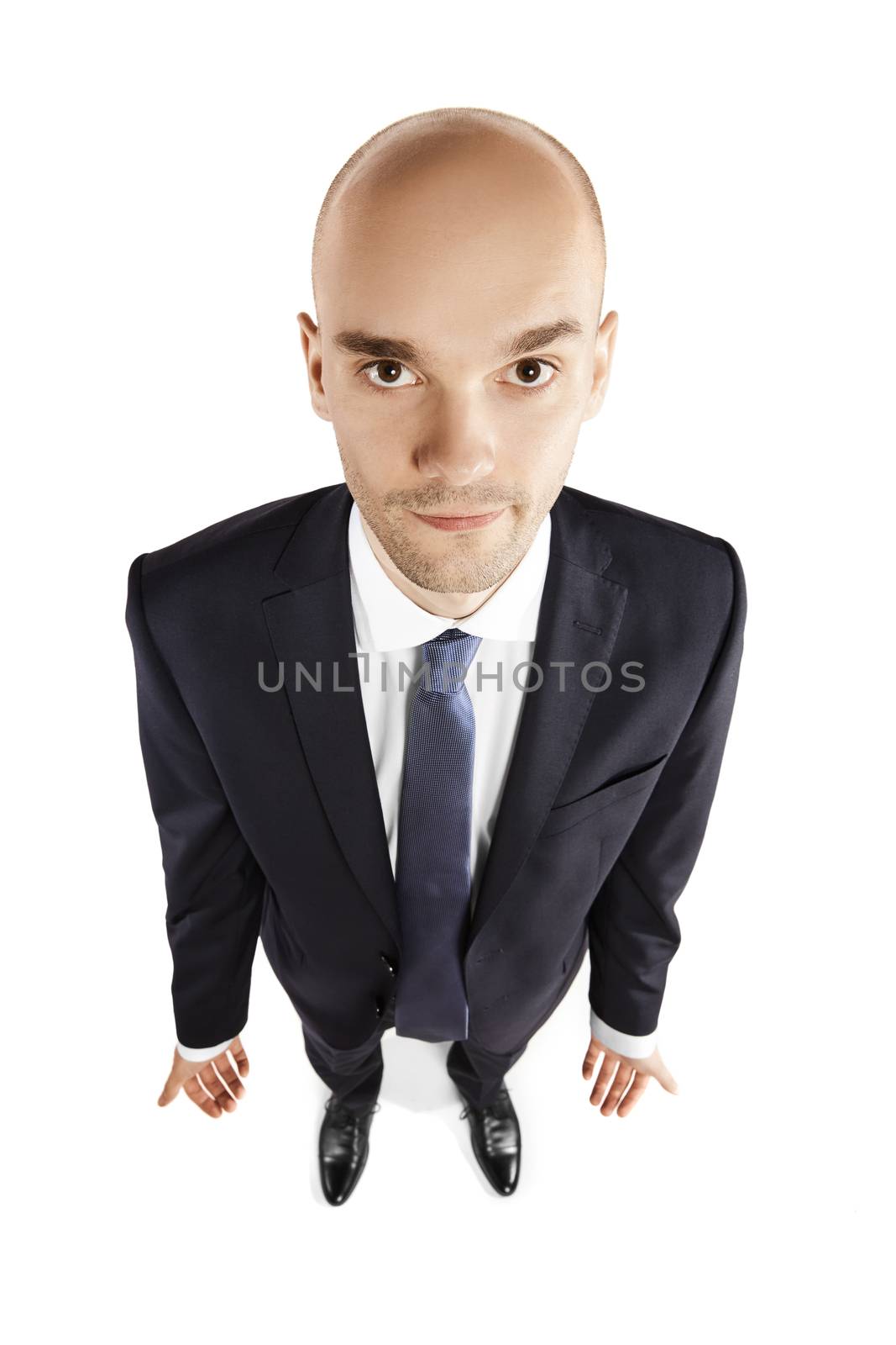 Overhead view of a young man looking up. Studio shot isolated on white background.