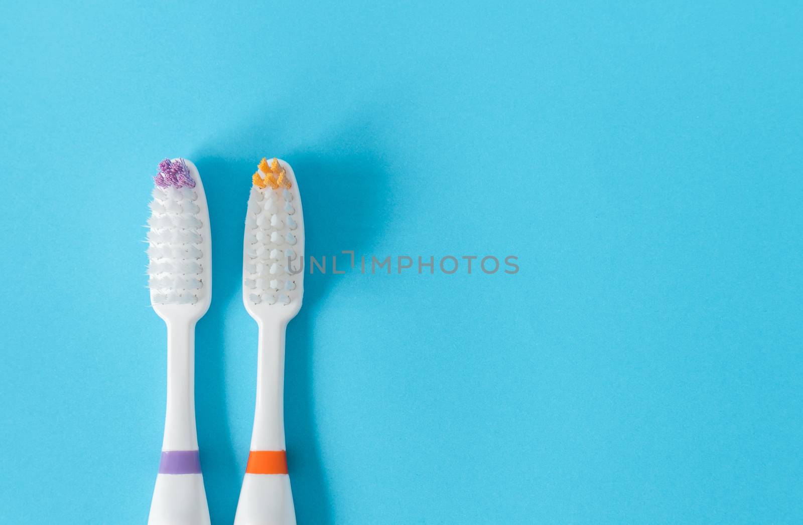 Closeup top view toothbrush on blue background