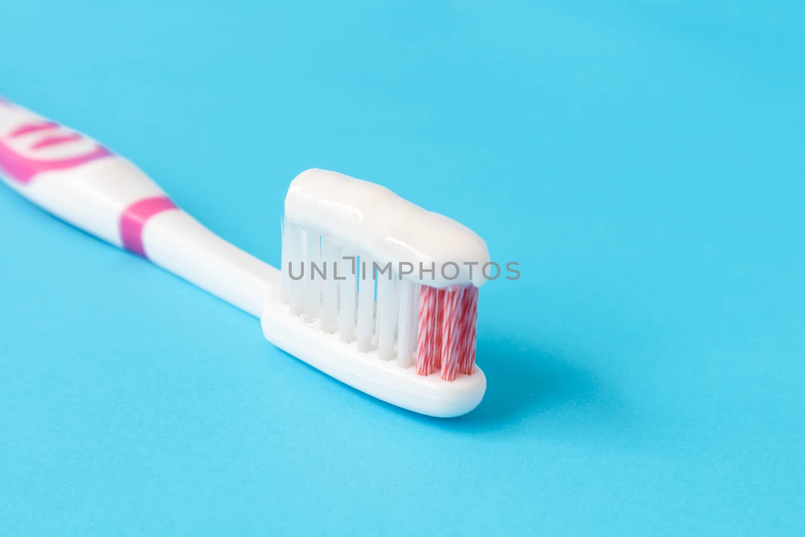 Closeup toothpaste with toothbrush on blue background by pt.pongsak@gmail.com