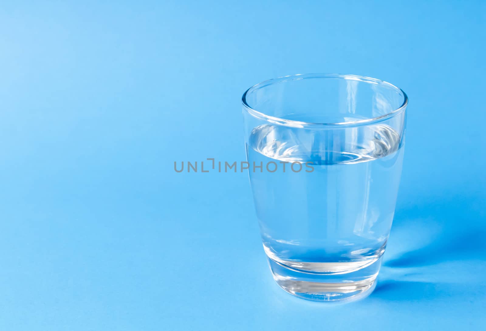 Water in glass on blue background by pt.pongsak@gmail.com