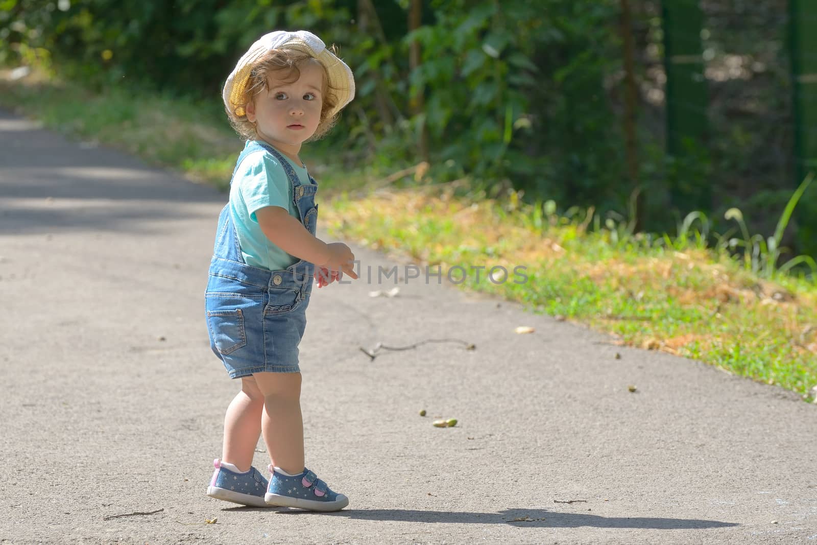 Little girl alone on street in summer