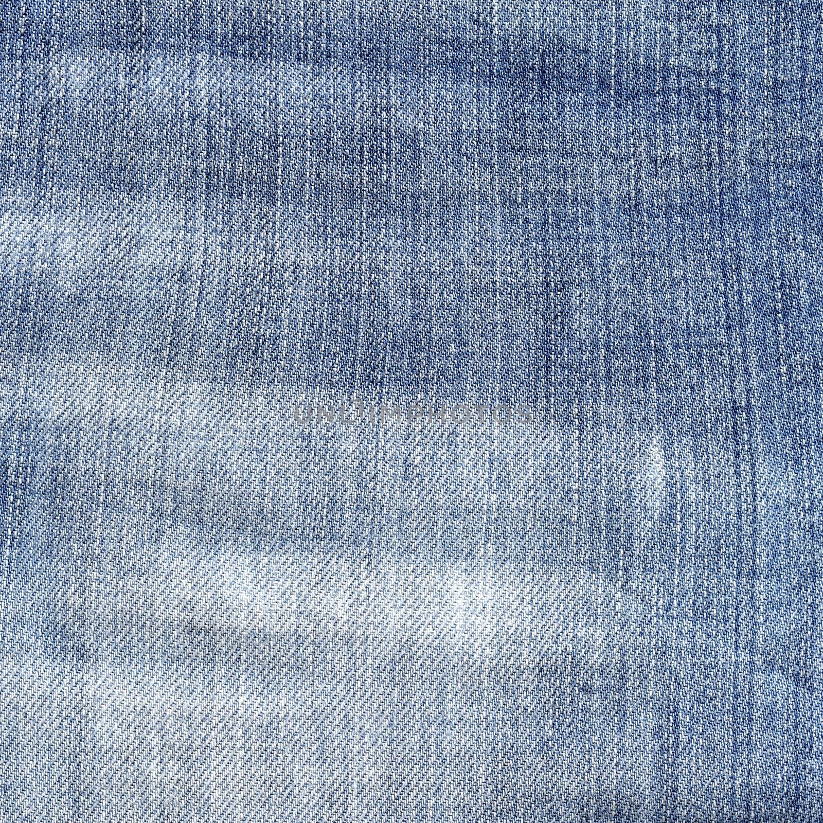 Shabby blue jeans texture. Light torn jeans