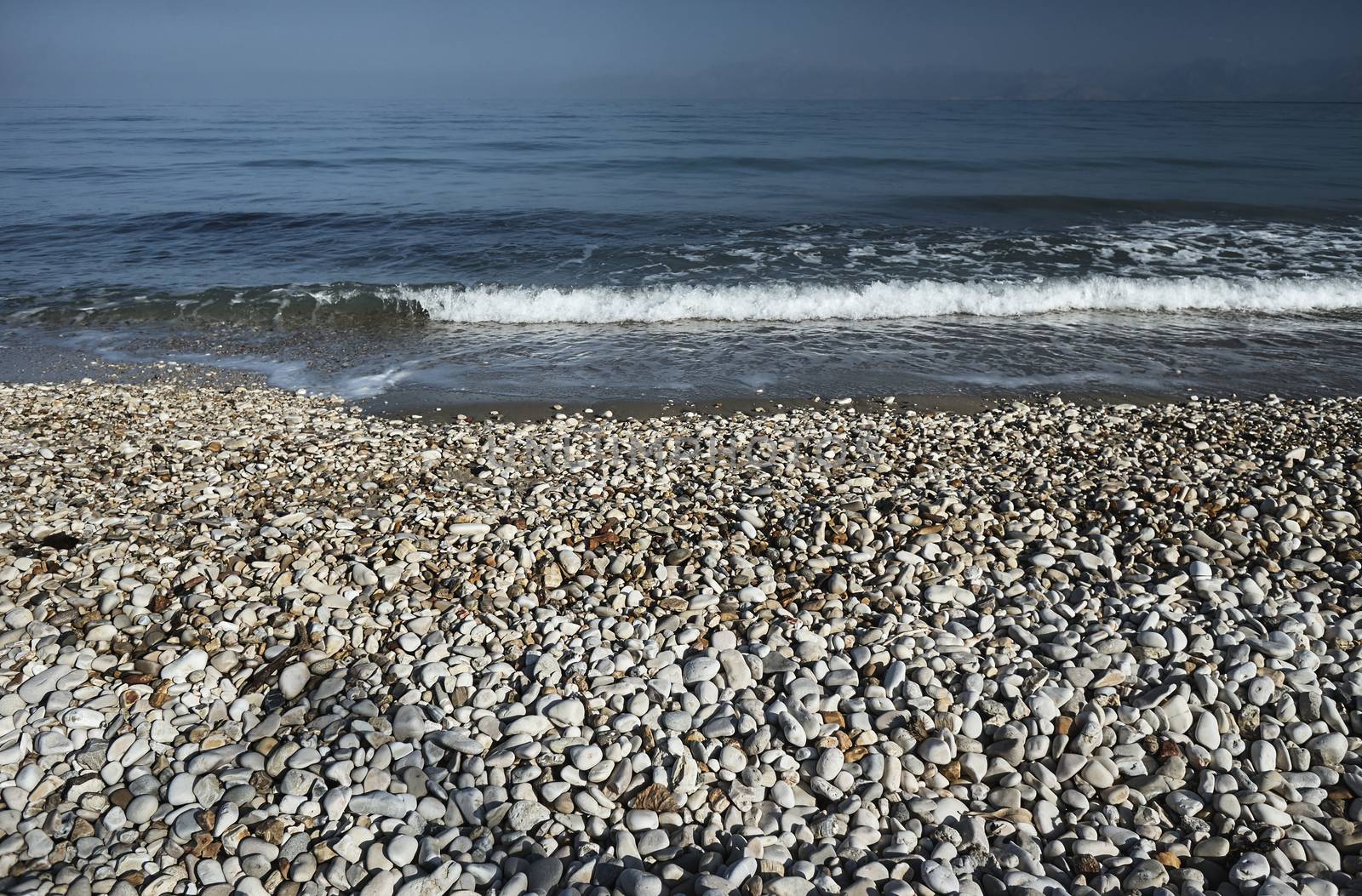 Pebbles on a sandy beach on the island of Corfu