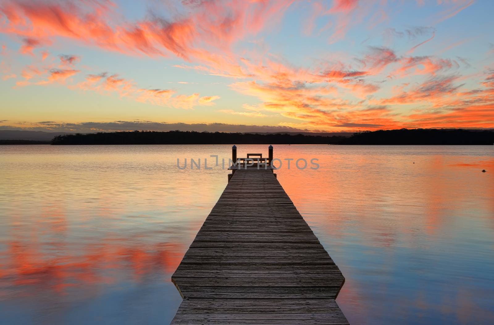 Sunset over the St Georges Basin with beautifully restored timber jetty.  This jetty was destroyed in the recent floods of August 2015