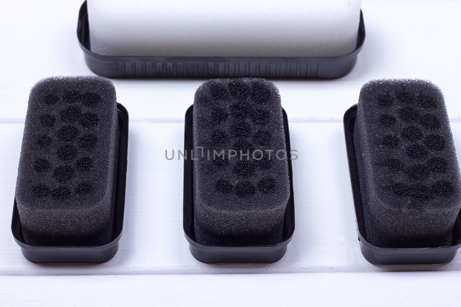 Black sponge for care of footwear on the white