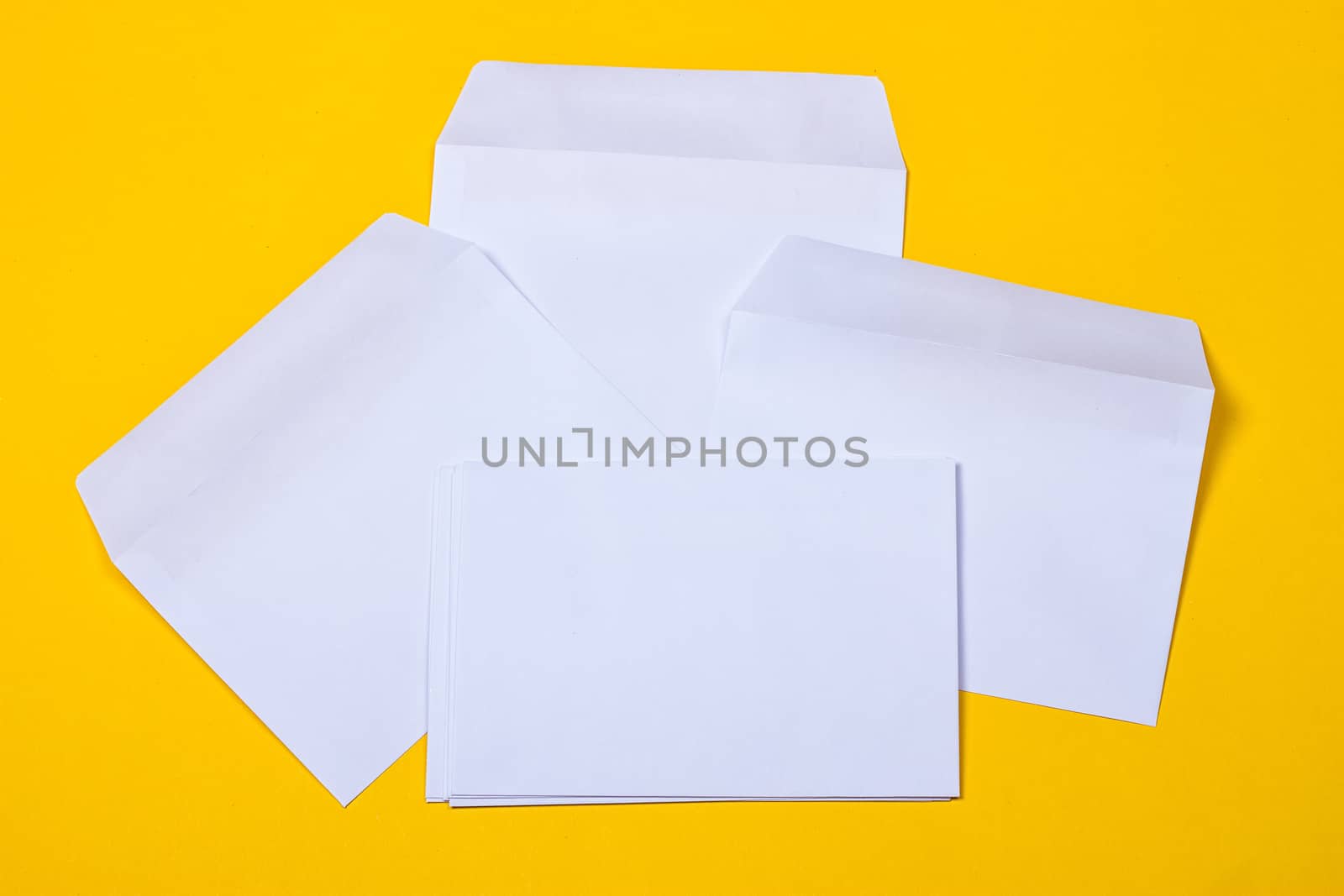 white open envelopes on the yellow background