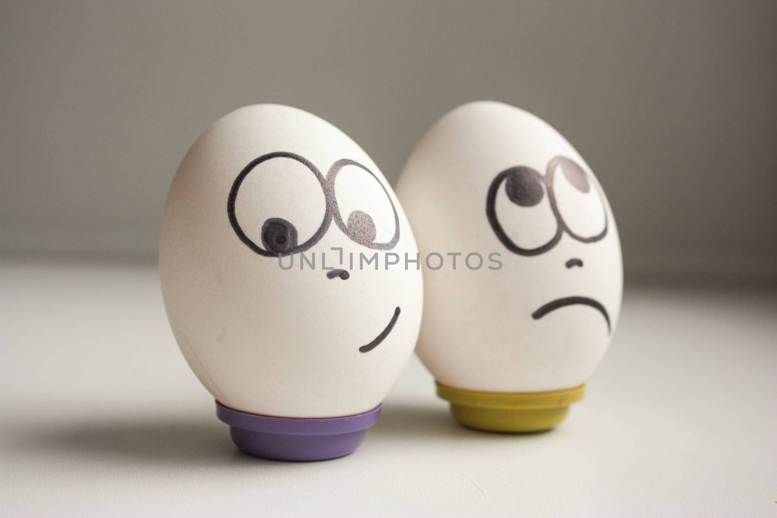 Pessimist and optimist concept. Eggs with painted face. photo for your design