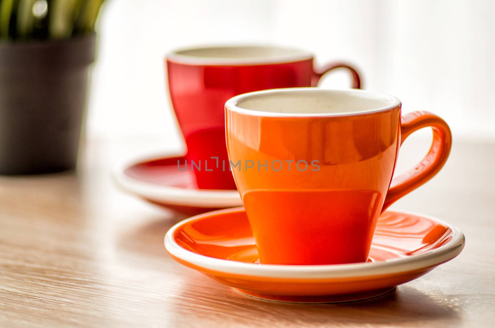 still life colorful tea cups on the wooden table by Desperada