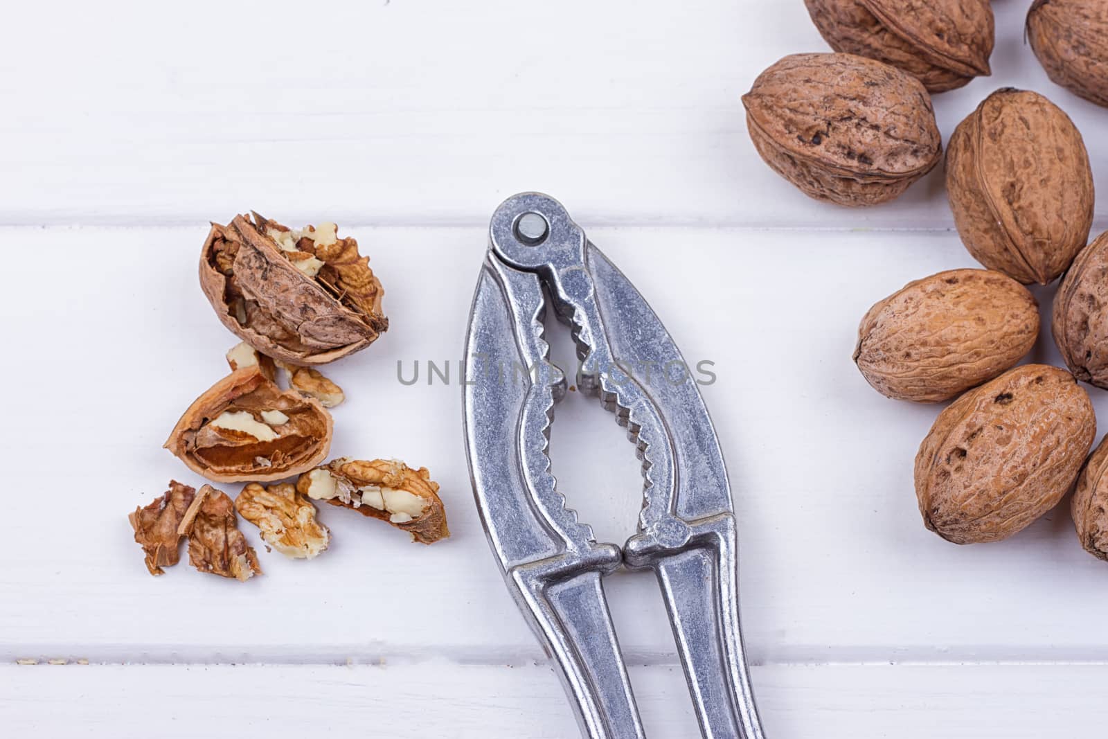 many walnuts on the white wooden background with copy-space