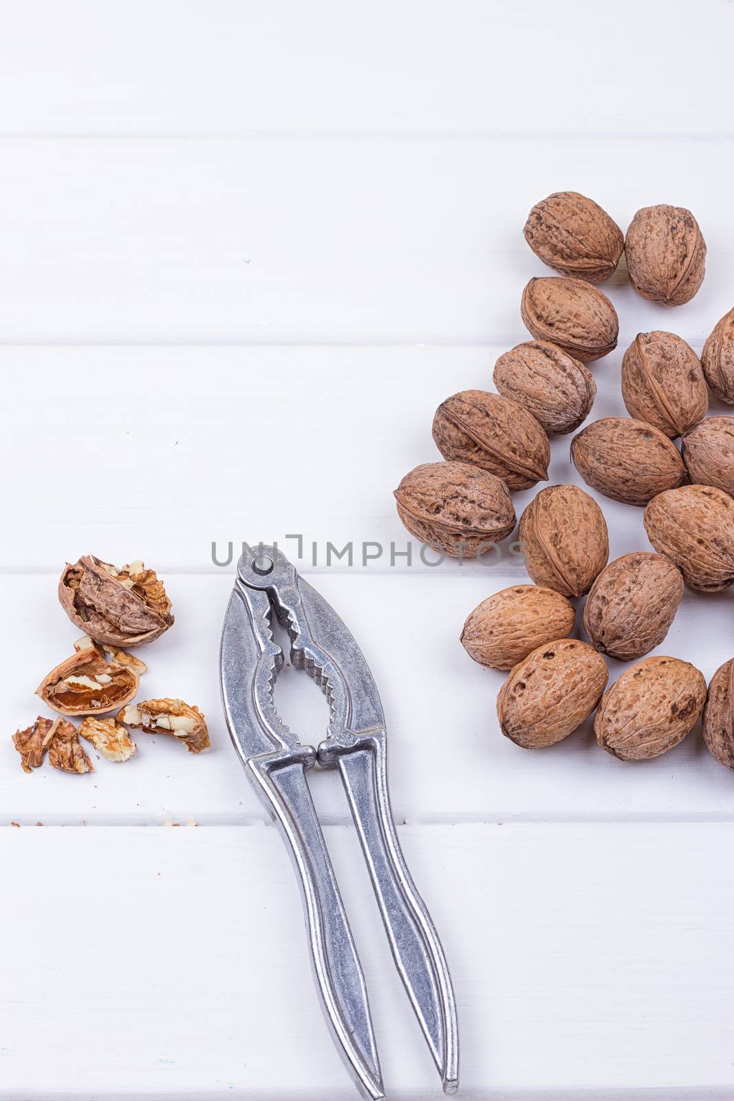 many walnuts on the white wooden background with copy-space