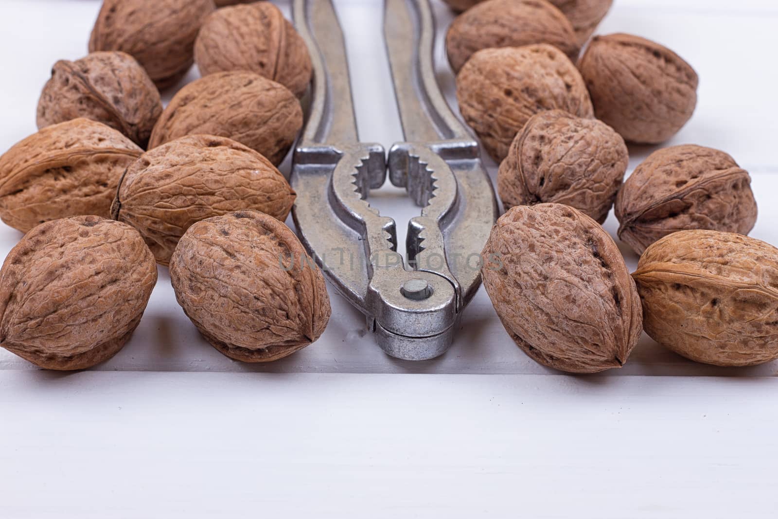 many walnuts on the white wooden background with copy-space